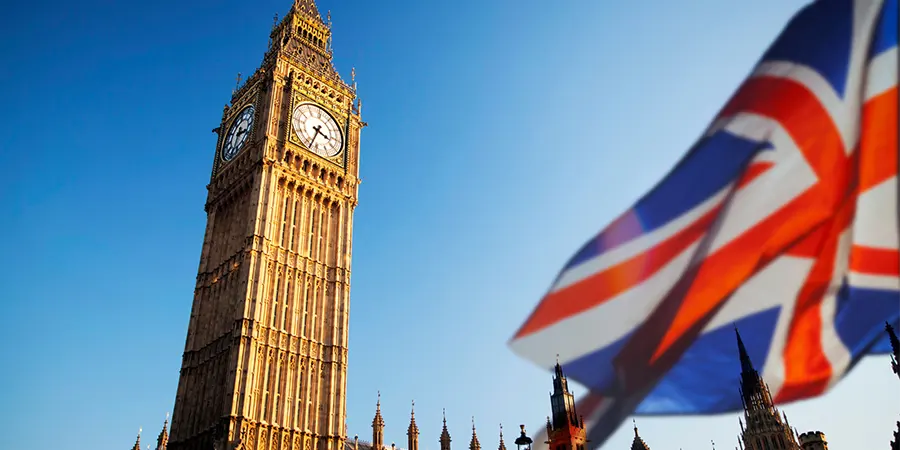 UK Parliament building with UK flag highlighting UK Budget 2025 Class 2 NIC changes for British expats in the US